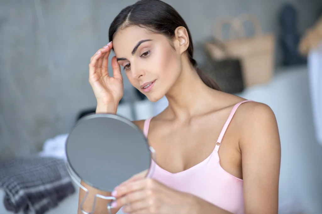 A women sees in mirror for Skin Care and Maintenance