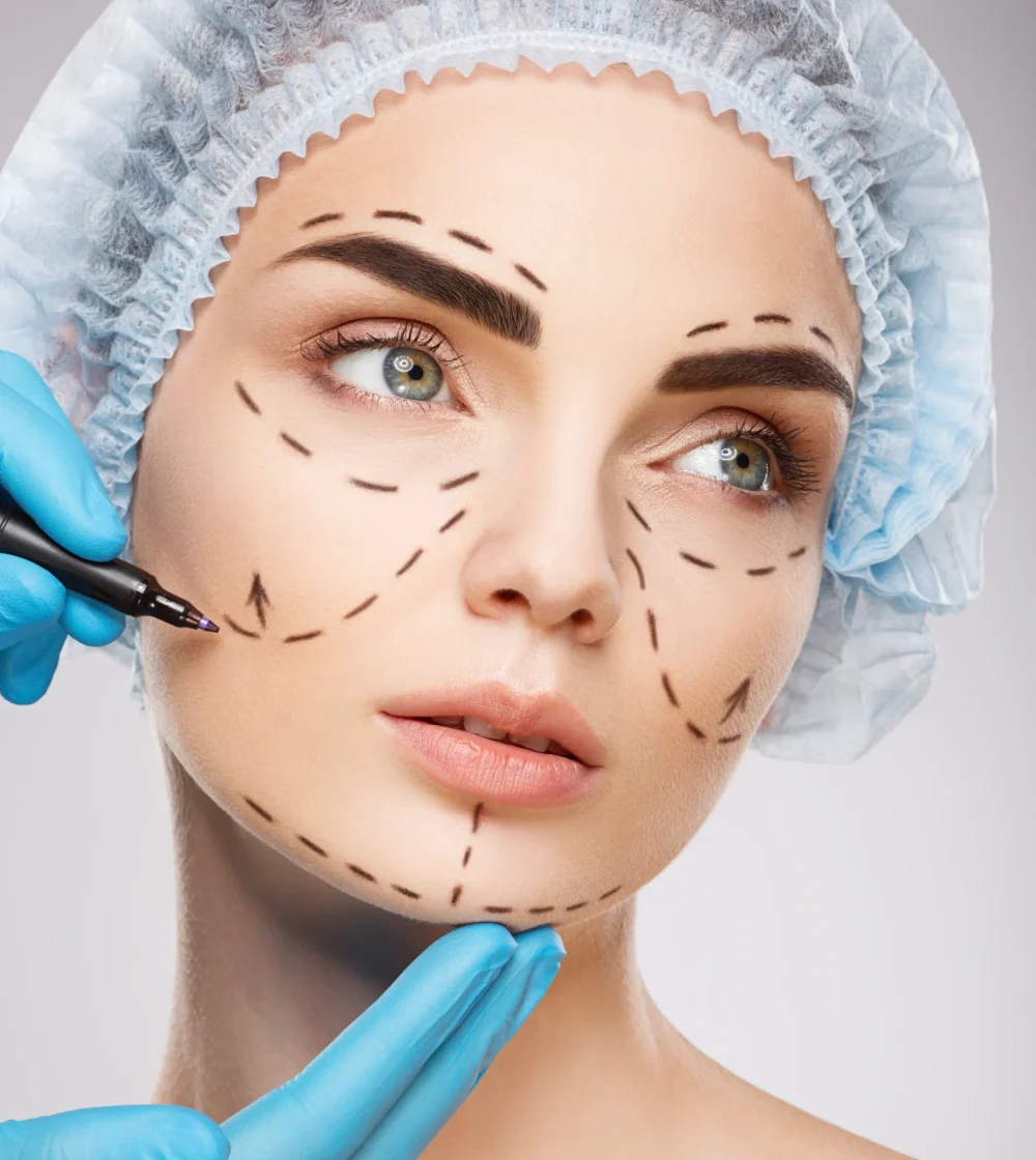 beautiful-girl-with-dark-eyebrows-wearing-blue-medical-hat-studio-background-doctor-s-hands-wearing-blue-gloves-drawing-perforation-lines-face